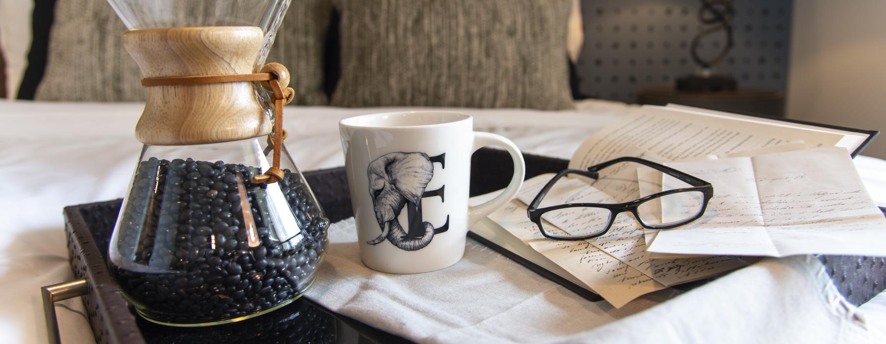 a table with glasses and a cup of coffee