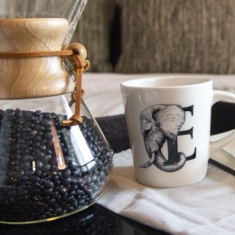 a table with glasses and a cup of coffee