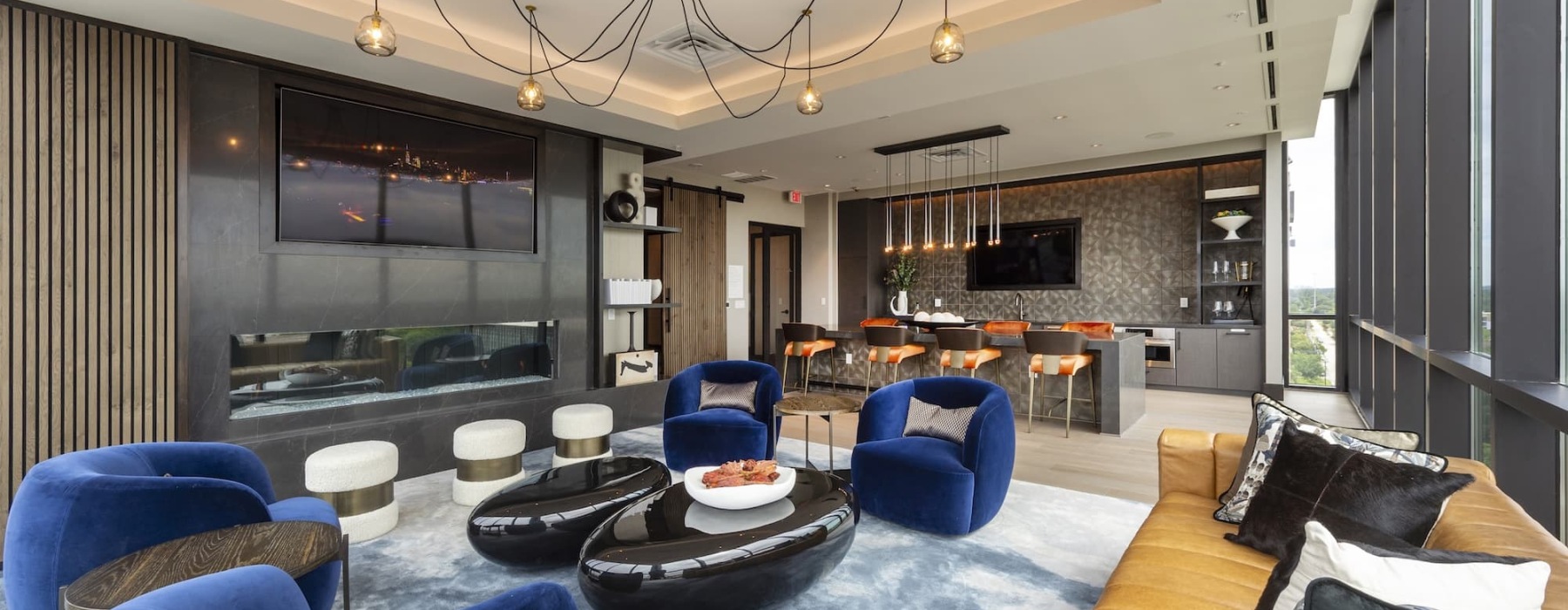 a room with a couch and chairs